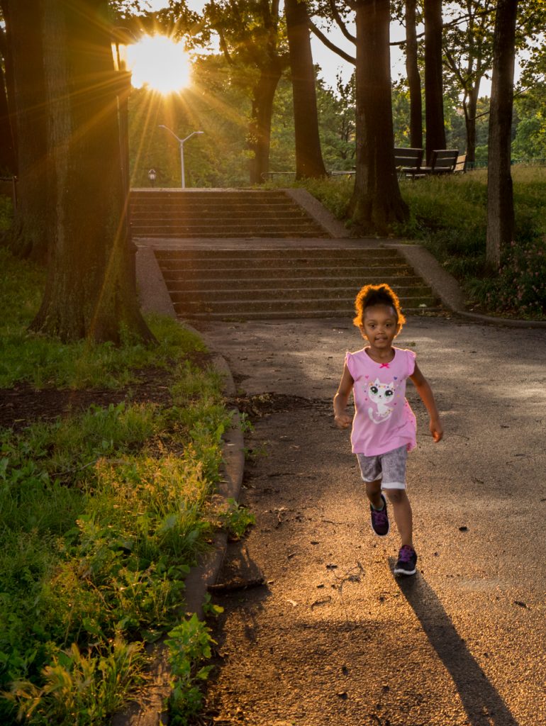 Little girl runs through grove of oak trees that were not flooded during Hurricane Sandy. Yet they were demolished in a flood control plan by New York City. © Pat Arnow photo